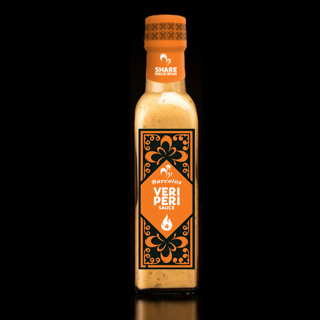 Barcelos Veri Peri Sauce bottle, branded as 'The Adventurer', displaying a fiery blend of bird's eye chili for a spicy kick. The image conveys a bold and challenging culinary adventure, enticing those ready to elevate their food experience with a daringly hot peri peri flavor.